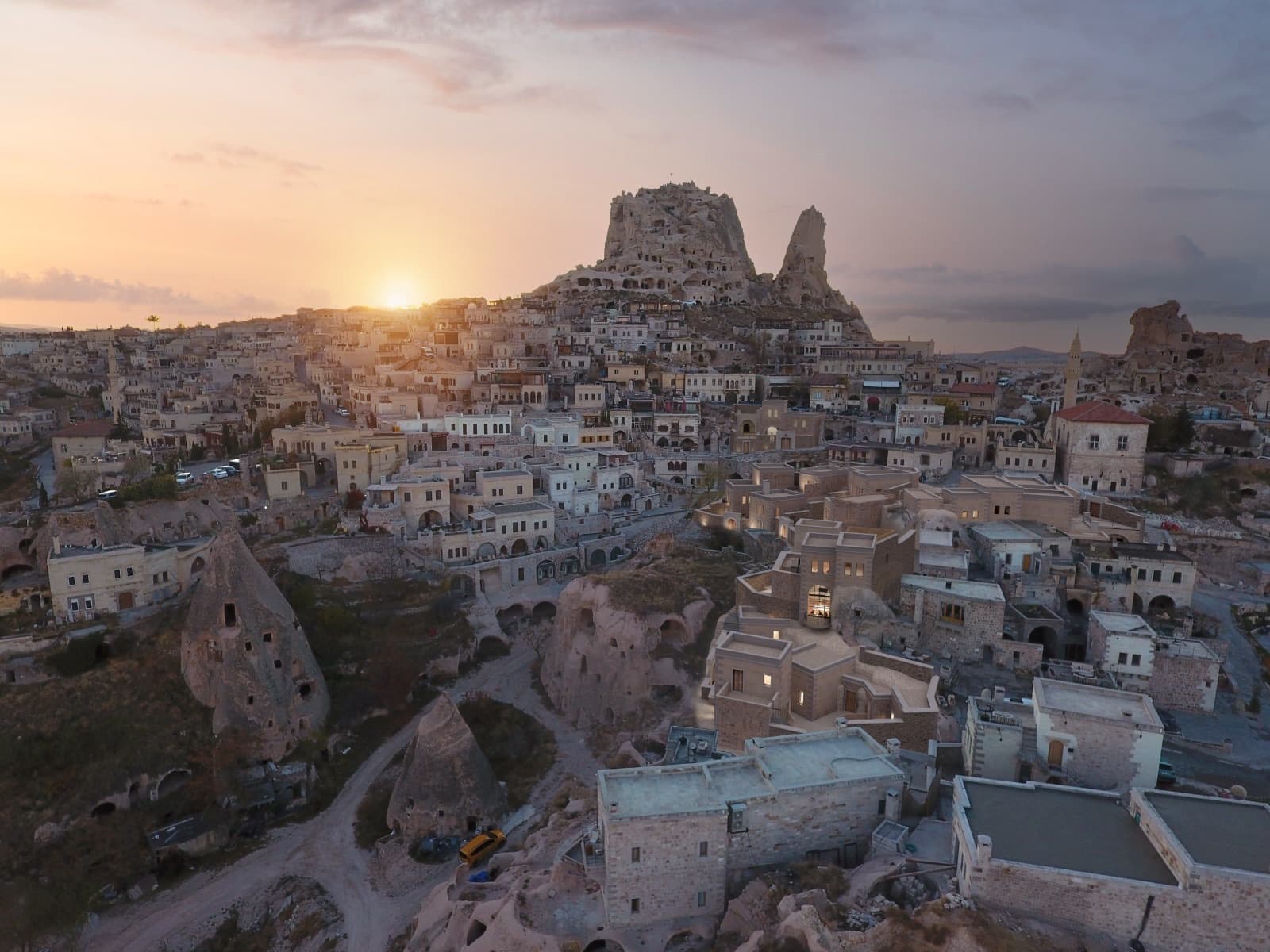 Uçhisar castle and the cave dwellings glowing at sunset