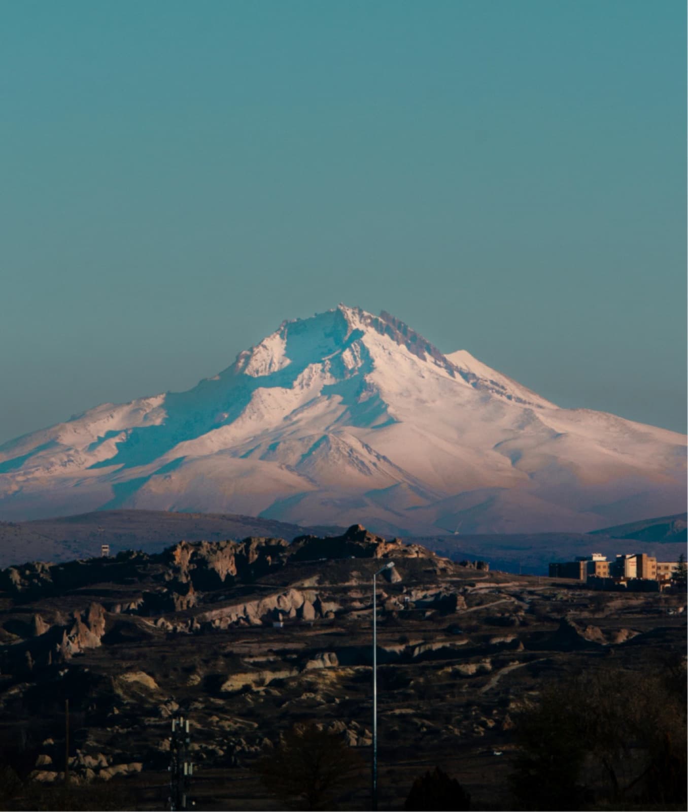 Snow-capped Mount Erciyes at dawn beyond the Cappadocia plateau